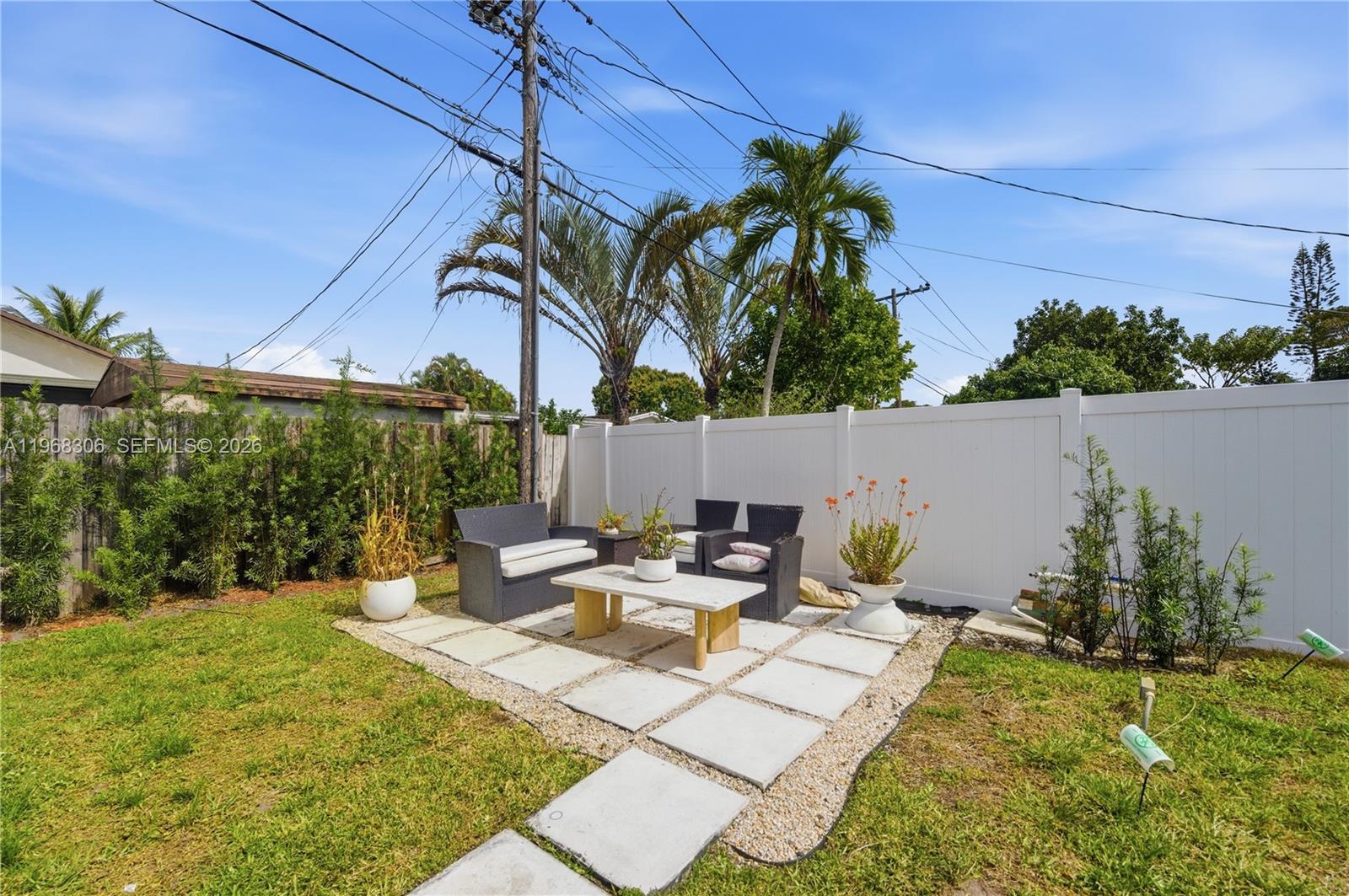 7491 Raleigh Street Hollywood, FL 33024 - Photo 18 of 28 a view of a patio with table and chairs potted plants