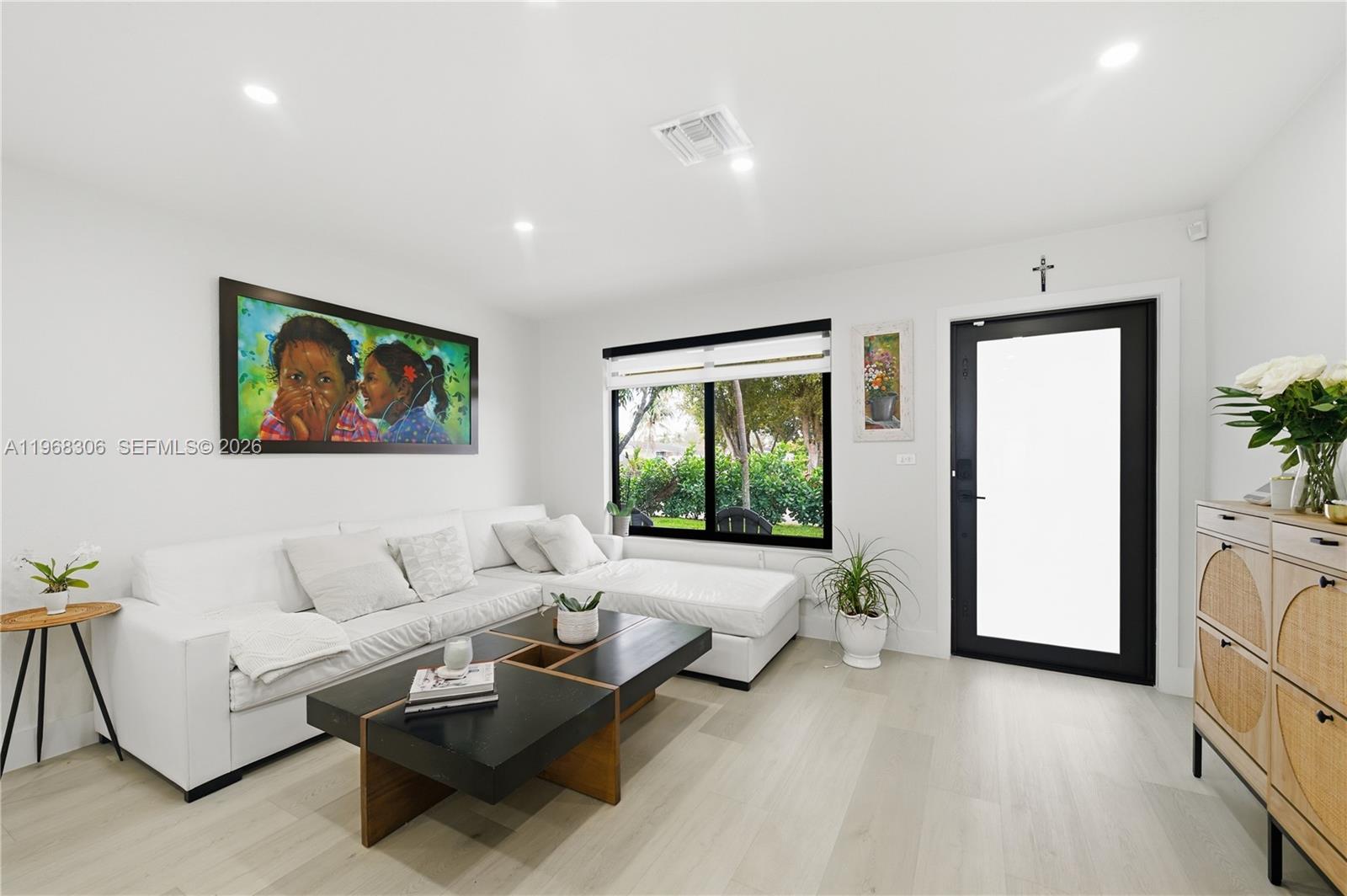 7491 Raleigh Street Hollywood, FL 33024 - Photo 2 of 28 a living room with furniture and a large window