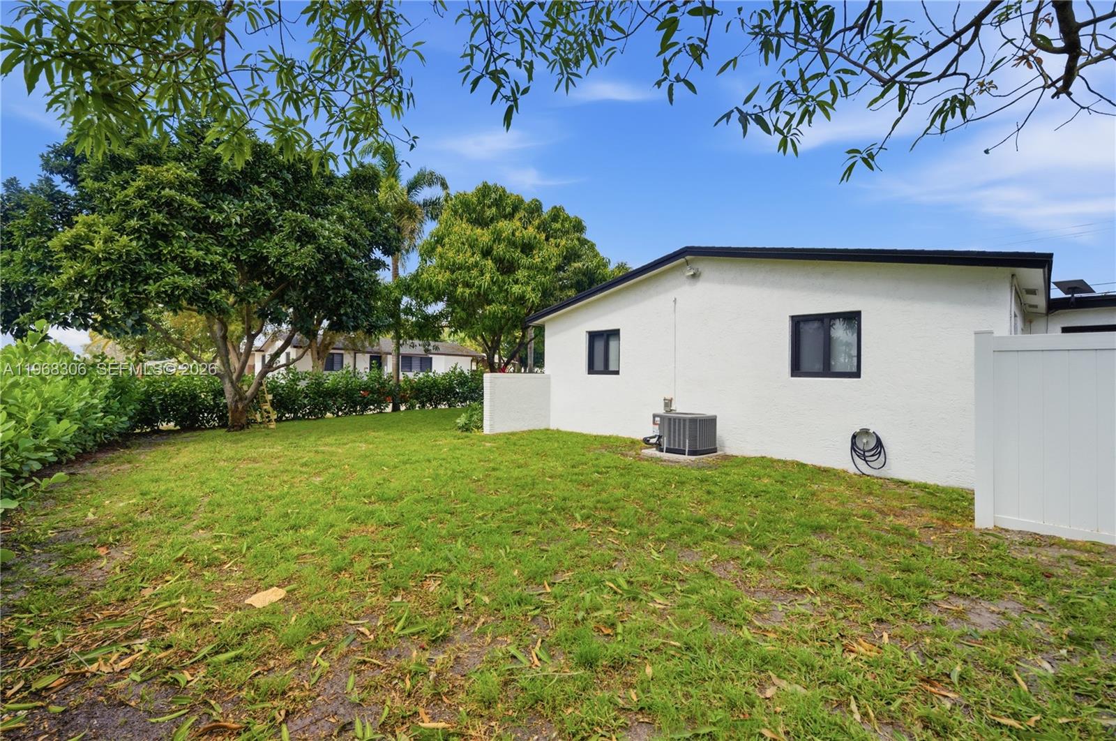7491 Raleigh Street Hollywood, FL 33024 - Photo 23 of 28 a backyard of a house with plants and large tree
