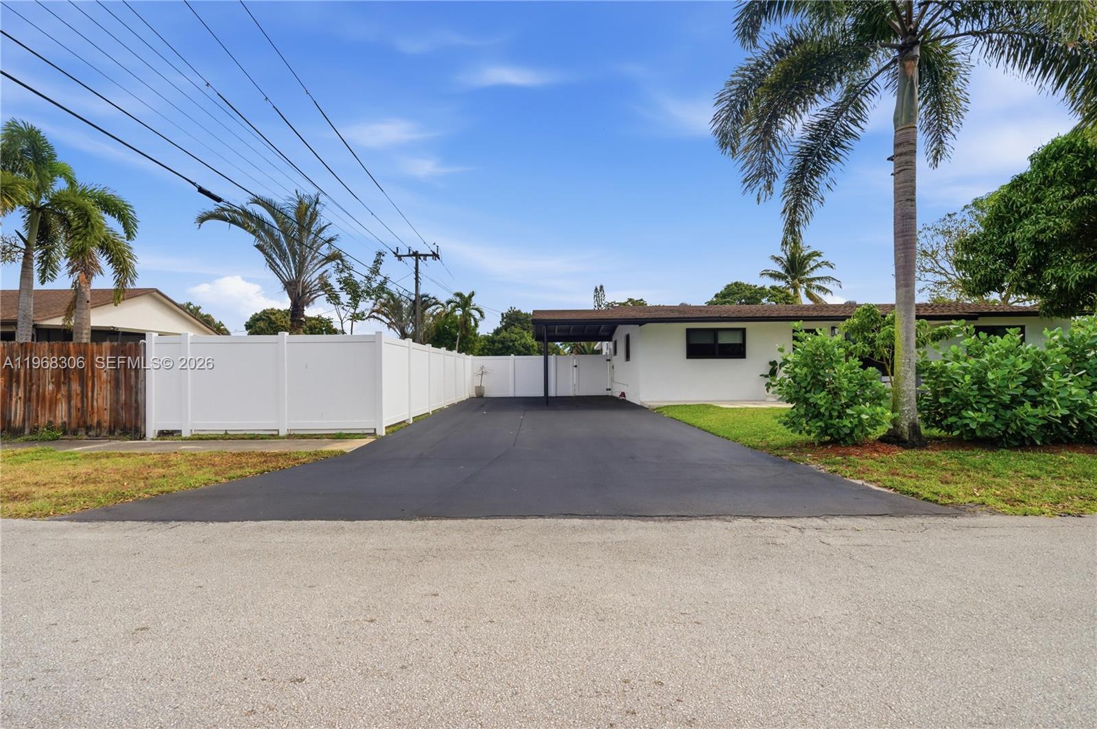 7491 Raleigh Street Hollywood, FL 33024 - Photo 27 of 28 a view of a house with a yard and palm trees