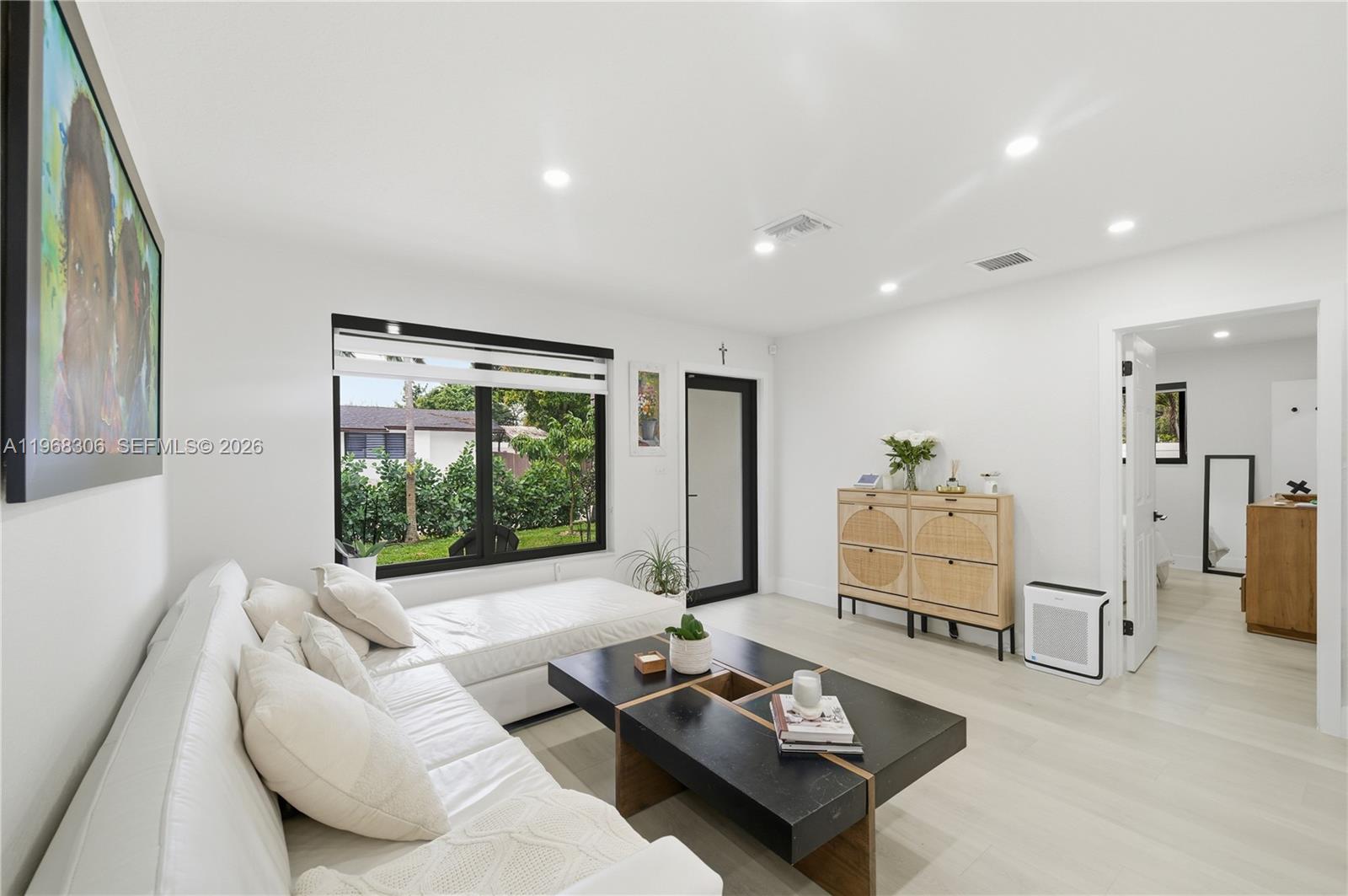7491 Raleigh Street Hollywood, FL 33024 - Photo 3 of 28 a living room with furniture and a large window