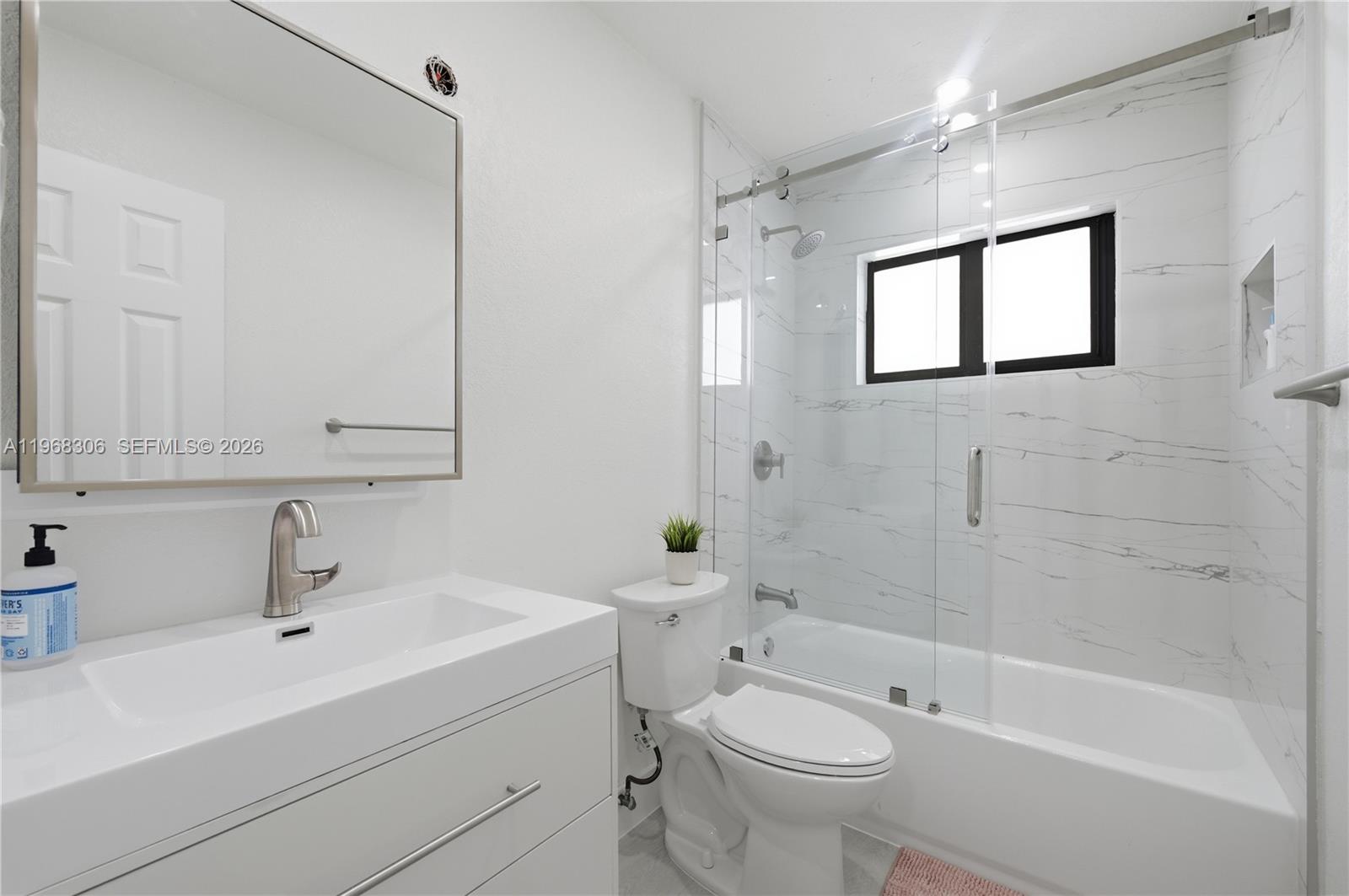 7491 Raleigh Street Hollywood, FL 33024 - Photo 6 of 28 a bathroom with a sink a toilet and shower