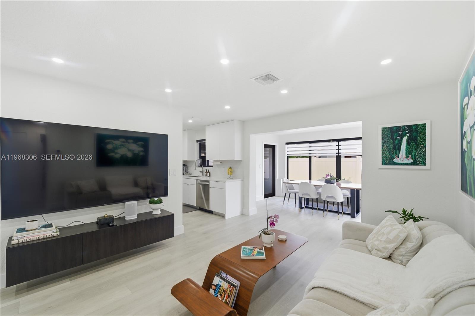 7491 Raleigh Street Hollywood, FL 33024 - Photo 10 of 28 a living room with furniture and a flat screen tv