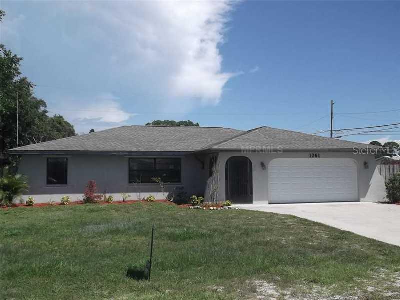 1261 Falcon Road Venice, FL 34293 - Photo 1 of 1 a front view of house with yard and outdoor seating