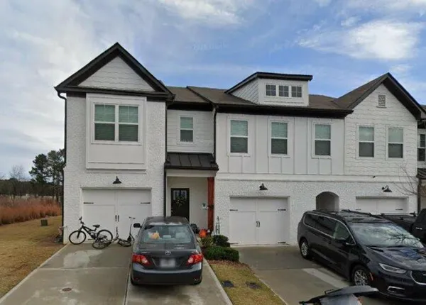 a front view of a house with parking