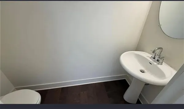 a bathroom with a sink toilet and a mirror