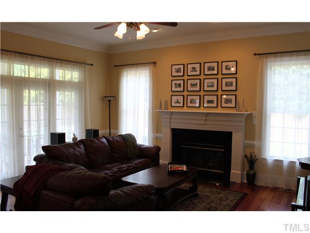 2108 Tulare Court Raleigh, NC 27612 - Photo 8 of 25 a living room with furniture a window and a fireplace