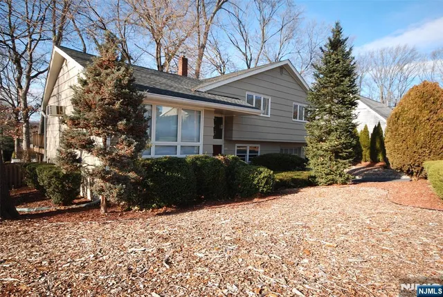 a view of a house with a yard covered in snow