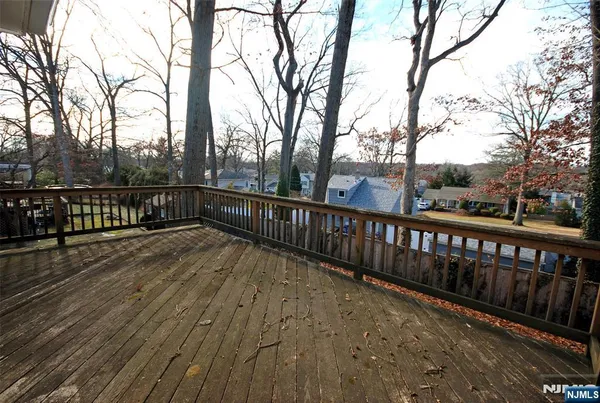 a view of balcony with wooden floor and fence