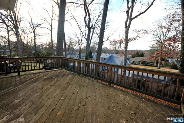 a view of balcony with wooden floor and fence