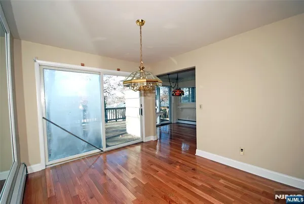 a view of a room with wooden floor and a window