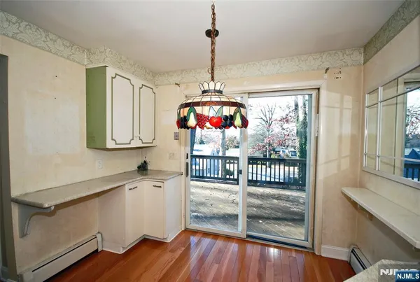 a view of a room with wooden floor and windows