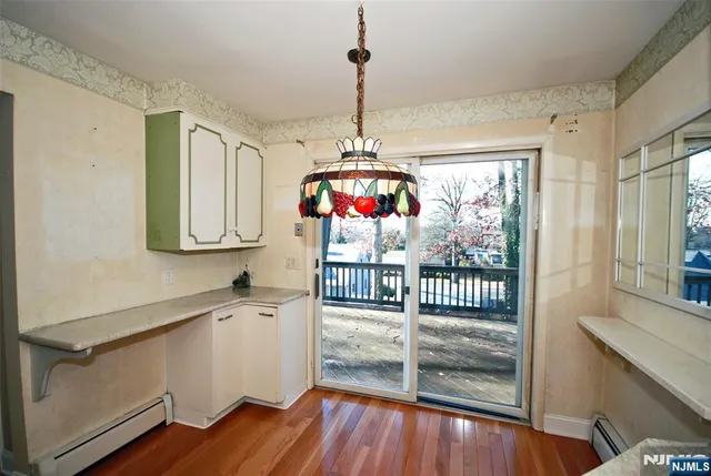 a view of a room with wooden floor and windows
