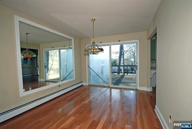 a view of a room with wooden floor and outdoor view