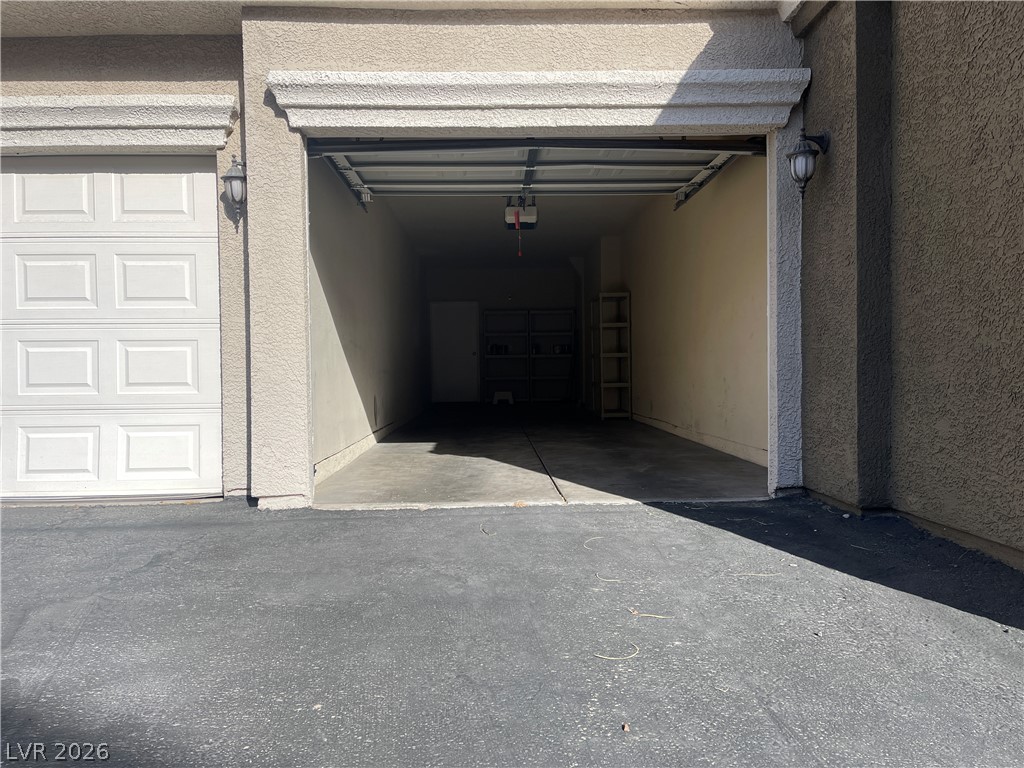 10001 Peace Way, Unit 1327 Las Vegas, NV 89147 - Photo 19 of 21 Secure parking and extra storage await within this convenient garage space.