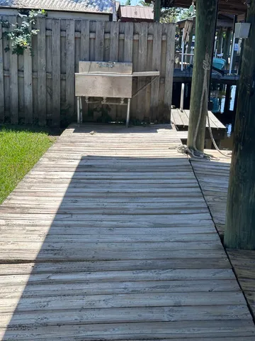 a view of a backyard with potted plants and wooden fence