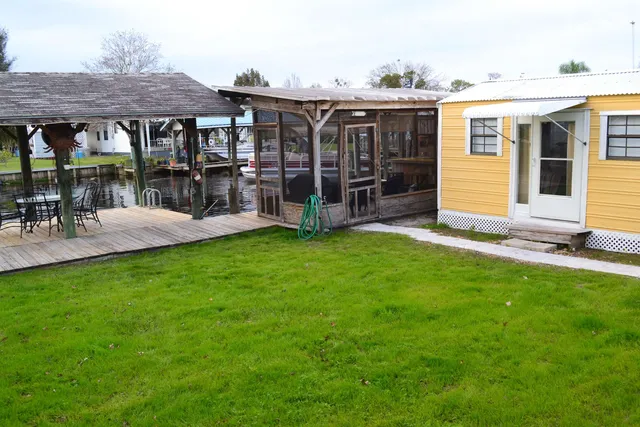 a view of a patio with a table and chairs under an umbrella