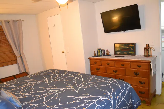 a bedroom with a bed and a chandelier