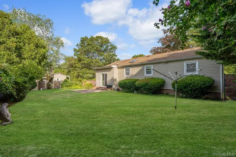 a view of a field of grass and trees