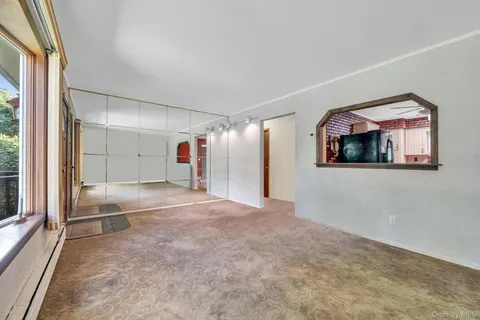 a view of a livingroom with wooden floor and windows
