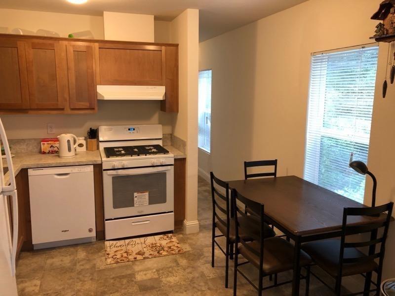 1833 Sams Lane Pollock Pines, CA 95726 - Photo 13 of 23 a kitchen with a stove a table and chairs