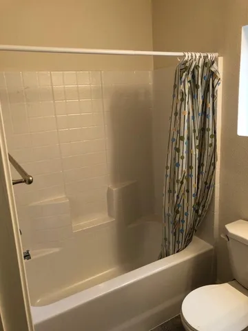 a bathroom with a shower and a toilet