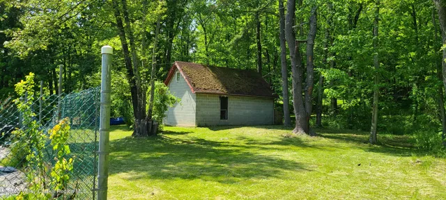 a view of a backyard with a small cabin