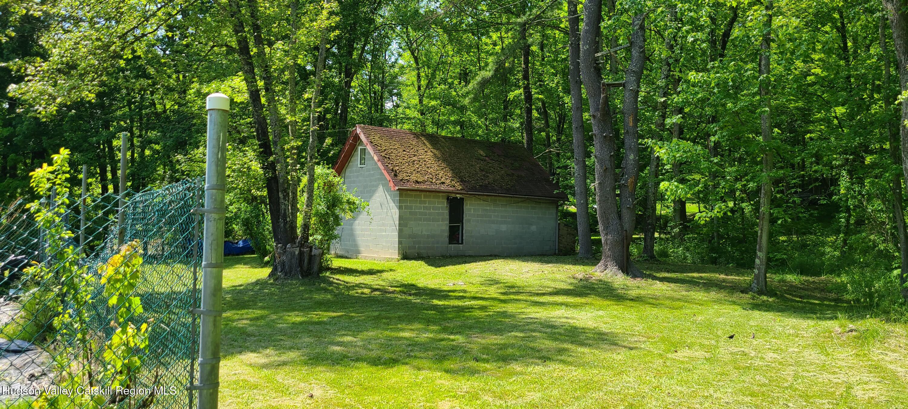 a view of a backyard with a small cabin