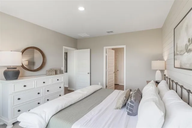 a bedroom with a bed and a dresser