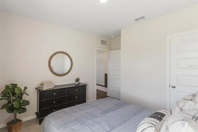 a bedroom with a bed and a dresser