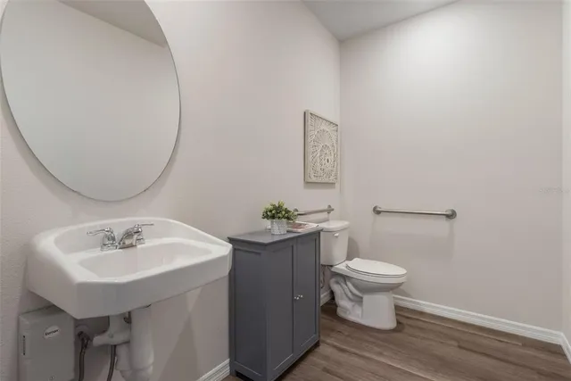 a bathroom with a sink toilet and a mirror