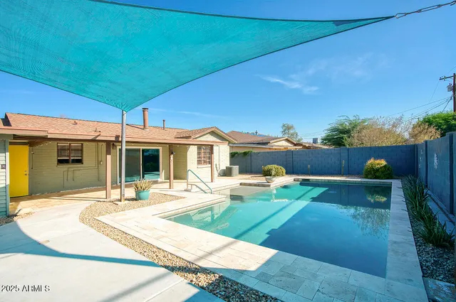 a view of a house with backyard and sitting area