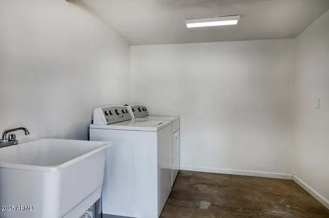 a utility room with sink dryer and washer