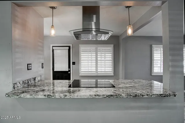 a view of a kitchen with a sink and a window