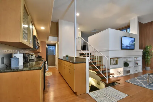 a view of a living room with furniture and a kitchen