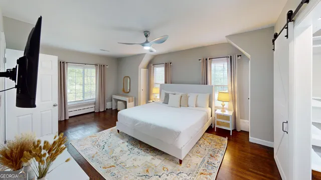 a bedroom with a large bed and a window