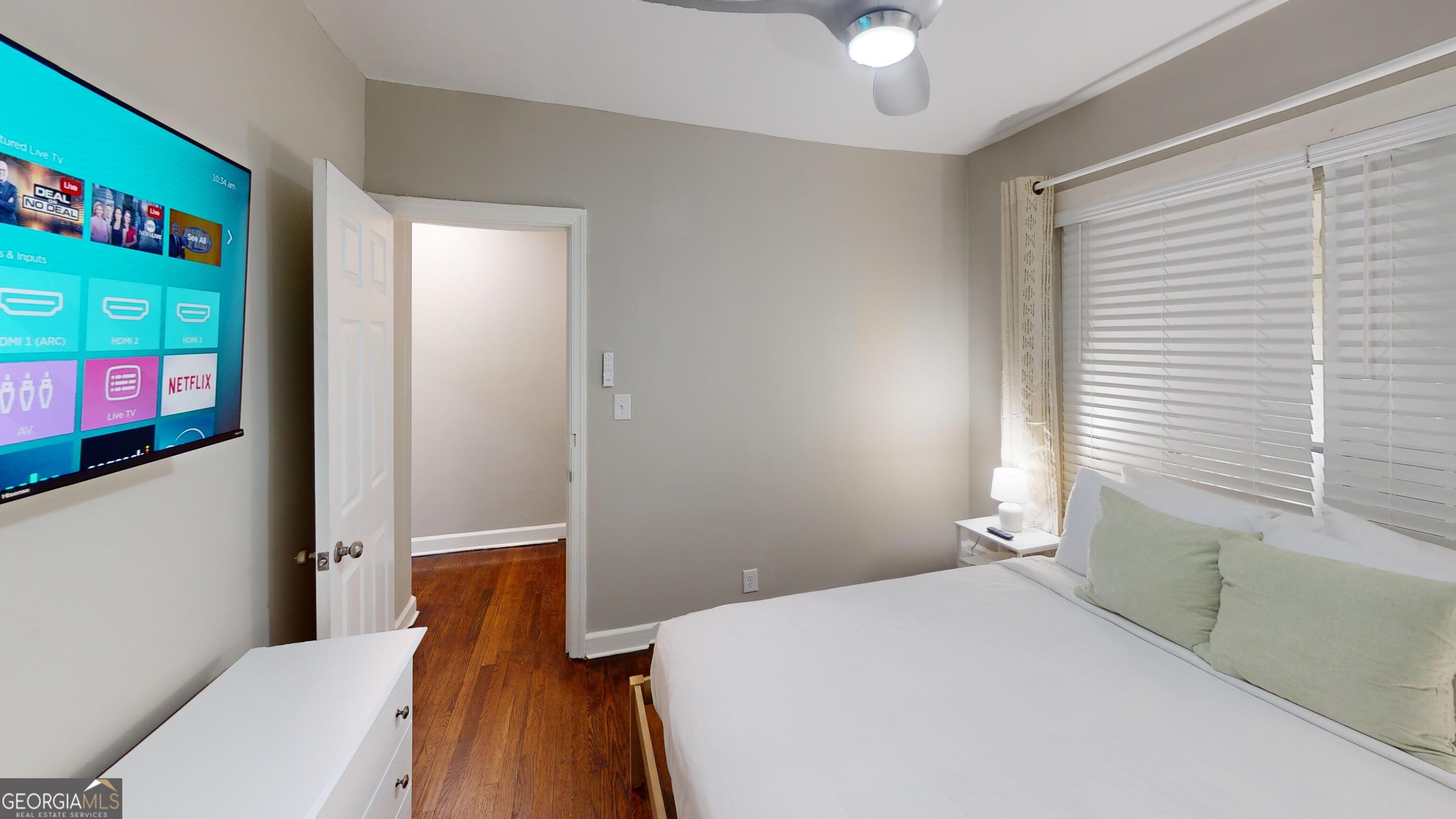 1114 Fayetteville Road Southeast Atlanta, GA 30316 - Photo 13 of 28 a bedroom with a bed and a chandelier