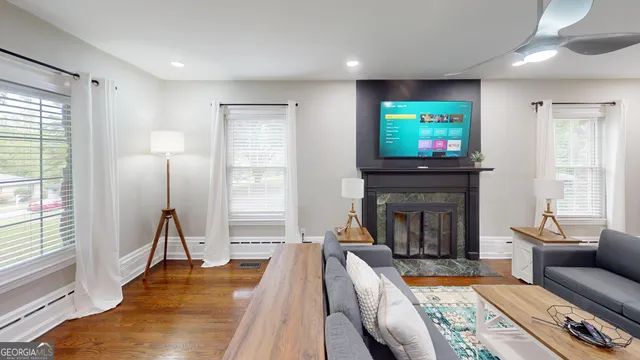 a living room with furniture and a flat screen tv