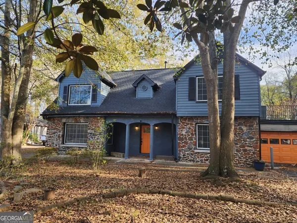 front view of a house with a tree