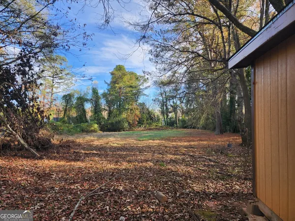 a view of a yard with large trees