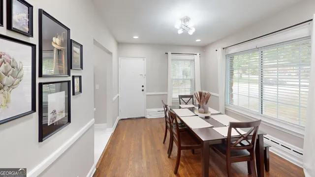 a view of a dining room with furniture window and wooden floor
