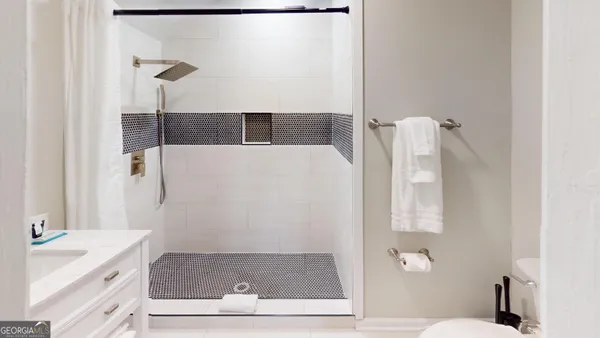 a bathroom with a shower and a sink
