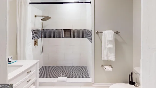 a bathroom with a shower and a sink