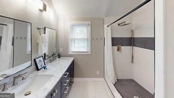 a bathroom with a tub sink and mirror