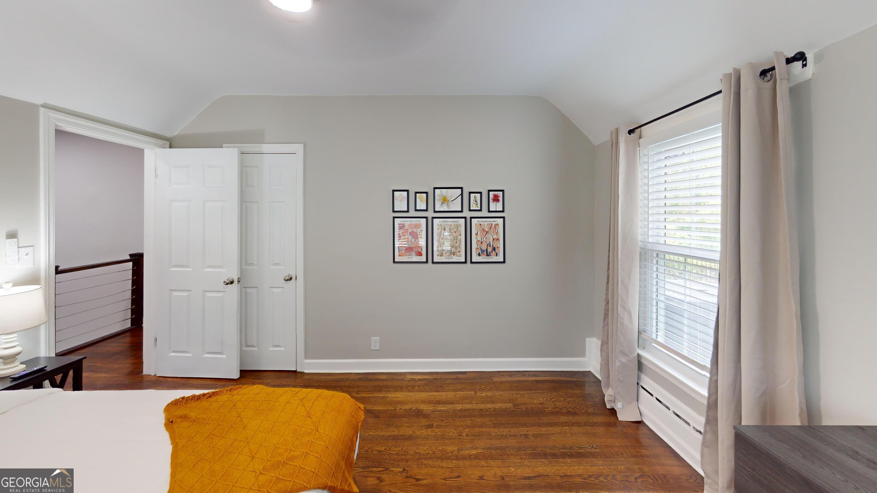 1114 Fayetteville Road Southeast Atlanta, GA 30316 - Photo 9 of 28 a view of a bedroom with window and wooden floor