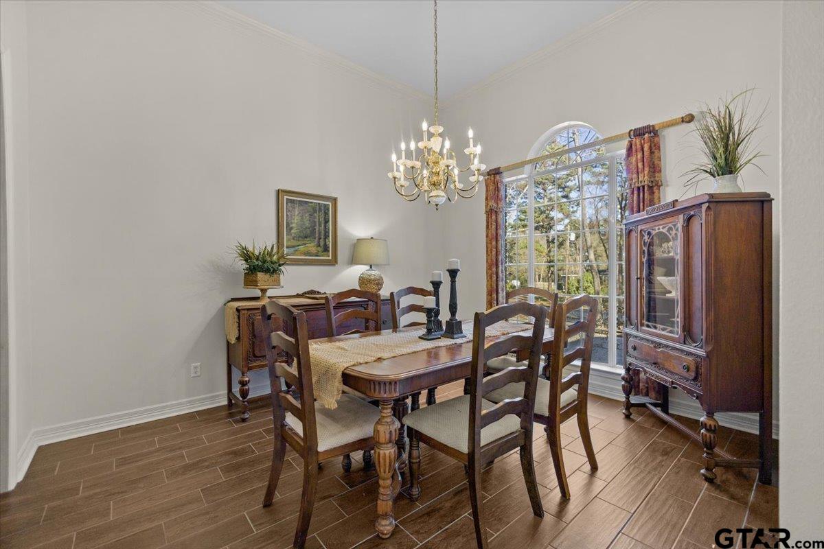 1336 Bridle Path Lane Hideaway, TX 75771 - Photo 18 of 48 a view of a dining room with furniture a chandelier and wooden floor