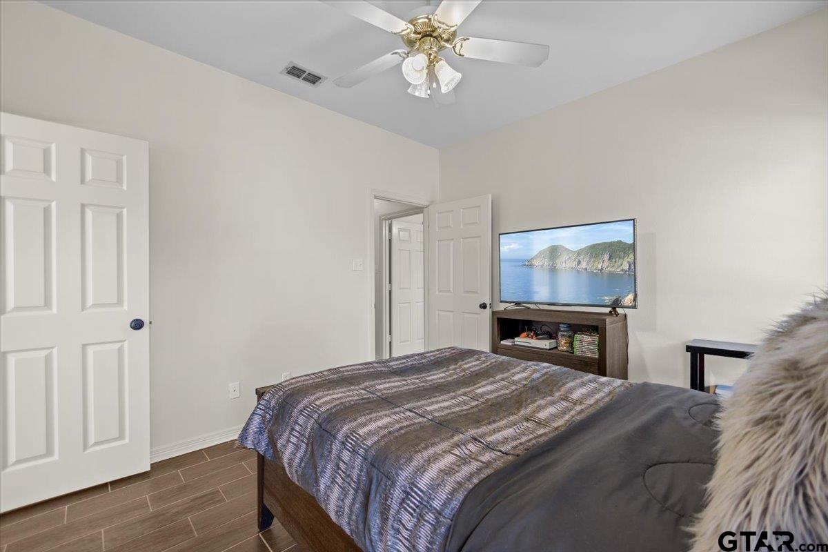 1336 Bridle Path Lane Hideaway, TX 75771 - Photo 23 of 48 a bedroom with a bed and a flat screen tv