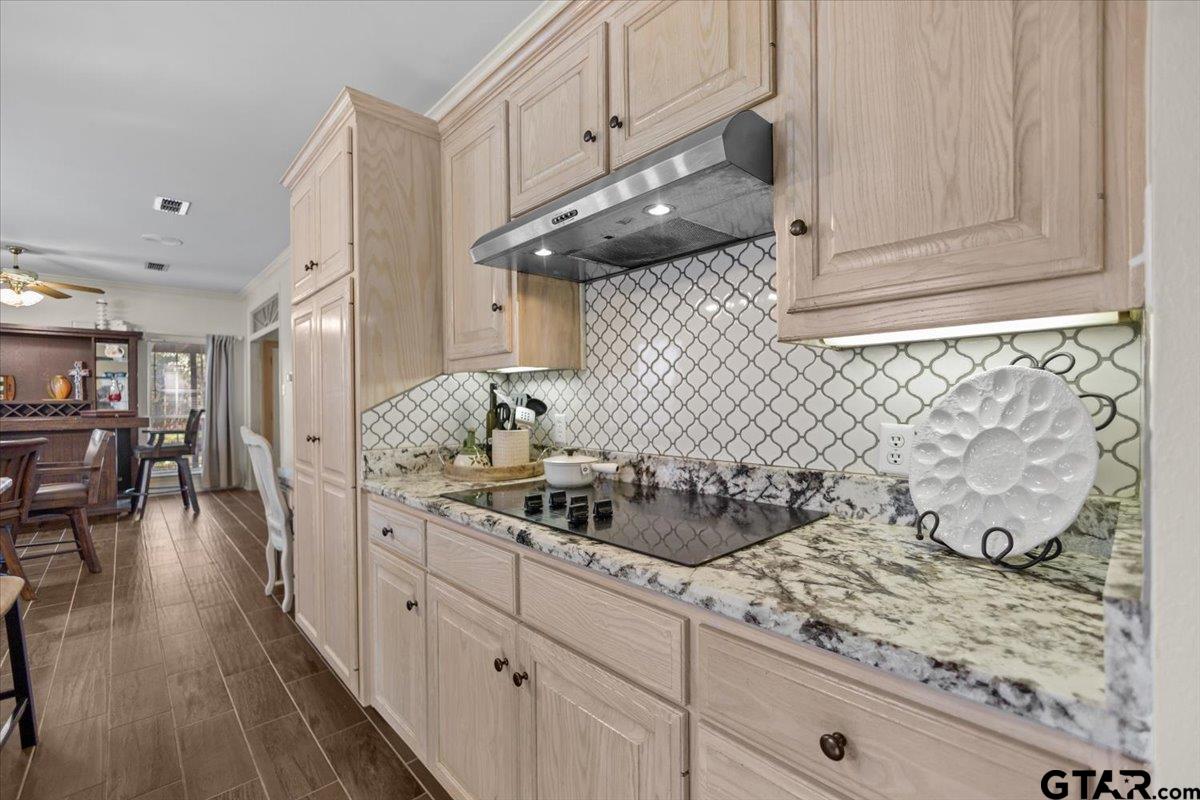 1336 Bridle Path Lane Hideaway, TX 75771 - Photo 36 of 48 a kitchen with stainless steel appliances granite countertop a sink dishwasher a stove a dining table and chairs with wooden floor