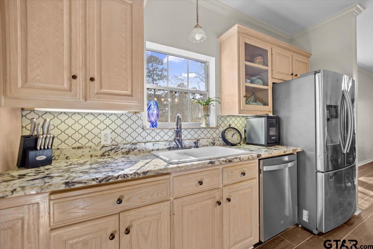 1336 Bridle Path Lane Hideaway, TX 75771 - Photo 37 of 48 a kitchen with granite countertop a sink stainless steel appliances and cabinets