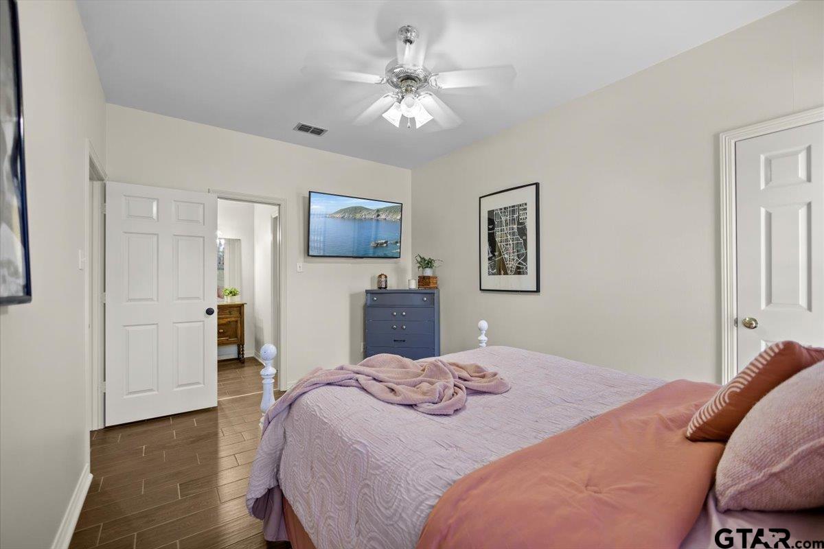 1336 Bridle Path Lane Hideaway, TX 75771 - Photo 4 of 48 a bedroom with a bed and a chandelier